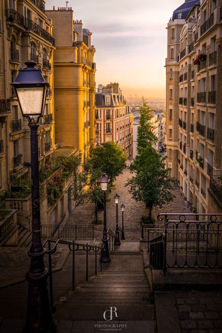 an alley way in the city at sunset