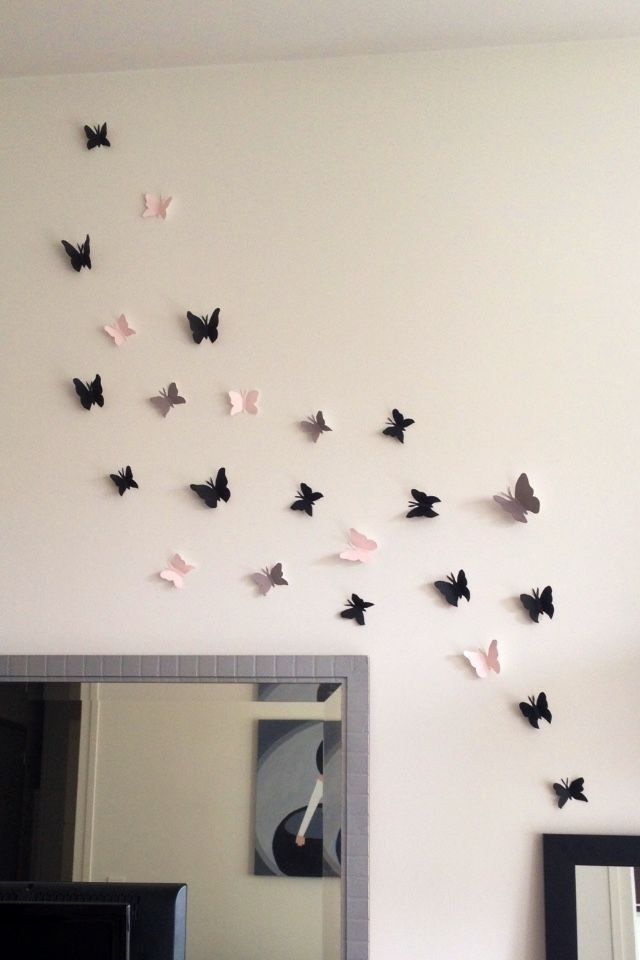 there are many butterflies on the wall in this room, and they look like they have been made out of paper