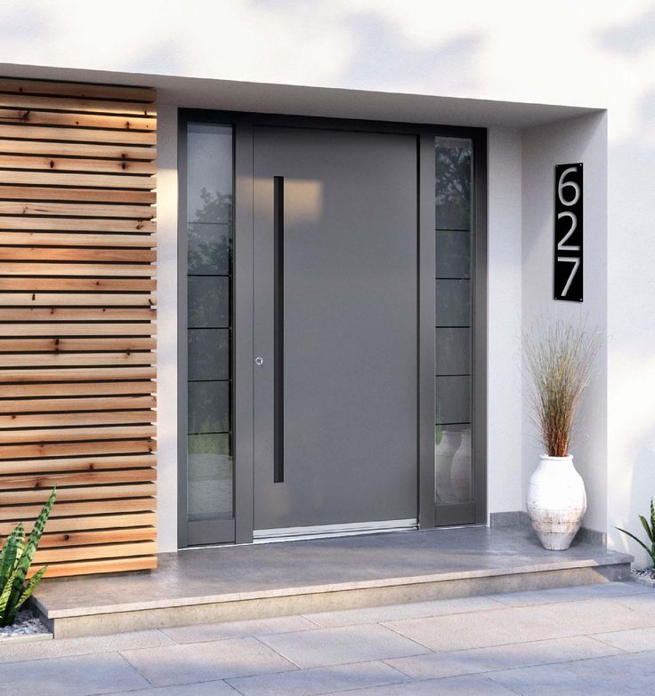 a modern entry door with glass panels and wood slats