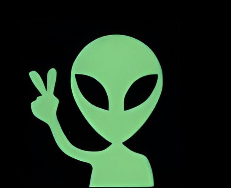 an alien is making the peace sign with his hand and it's eyes glowing green