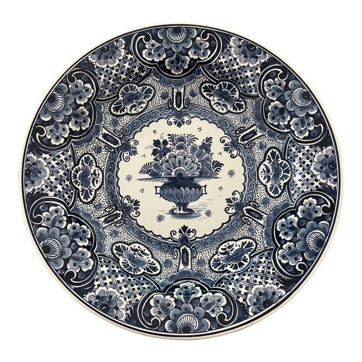 a blue and white plate with flowers on it