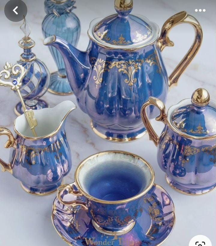 blue and gold tea set with matching saucers