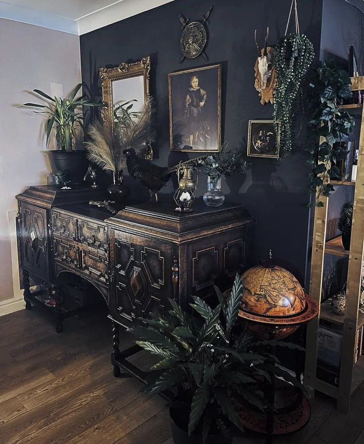 a room filled with lots of plants and pictures on the wall next to a table