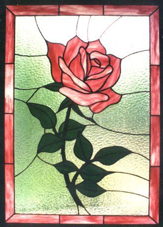 a stained glass window with a rose on it