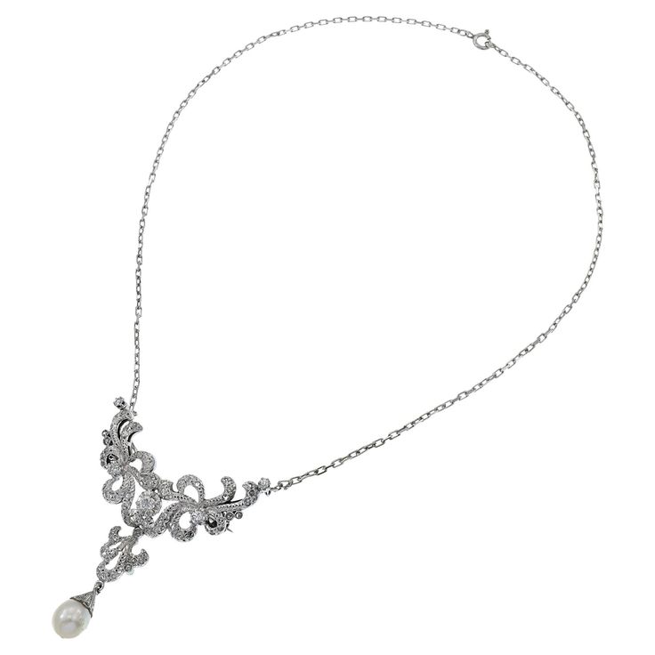 This elegant estate Victorian Era piece, weighing 12.10 grams, serves as both a necklace and a pin. It is crafted in platinum and features old mine cut diamonds totaling 2.66 carats. The design is completed with a beautiful pearl drop, adding a touch of classic sophistication. This versatile piece is perfect for adding vintage charm and elegance to any ensemble, making it a timeless addition to any jewelry collection. Diamond Drop Necklace, Pearl And Diamond Ring, Enamel Necklaces, Cluster Necklace, Antique Necklace, Diamond Drops, Drop Necklace, Link Necklace, Pearl Drop