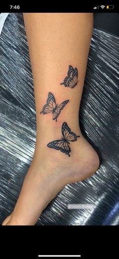 a woman's foot with three butterflies tattooed on the side of her leg and ankle