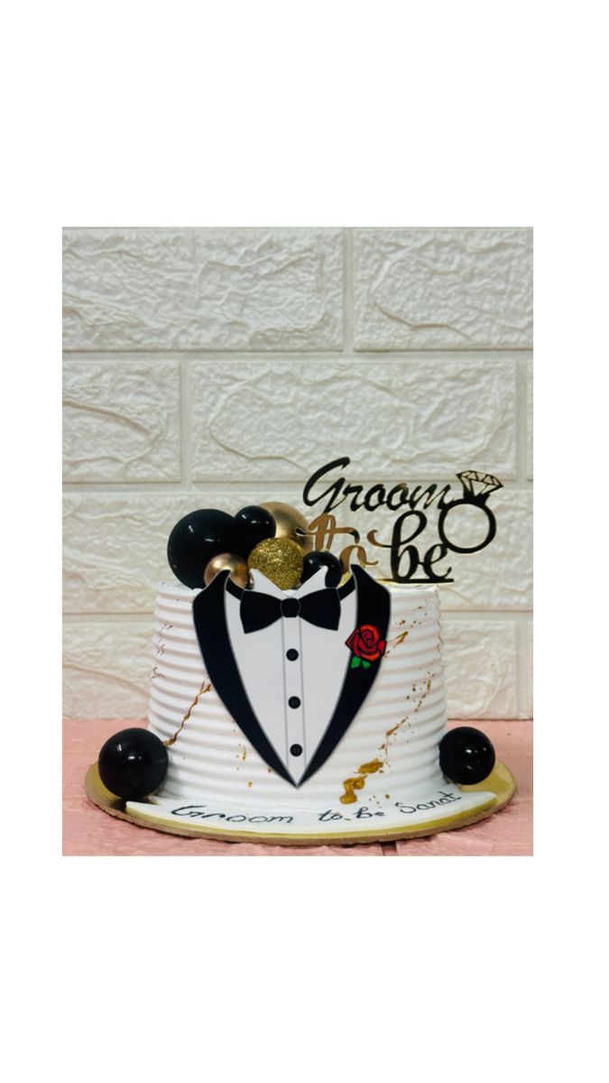 a white cake with black and gold decorations