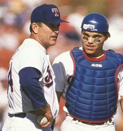 two baseball players standing next to each other