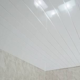 the ceiling in this bathroom is white and has light colored tiles on it, along with a beige tile floor