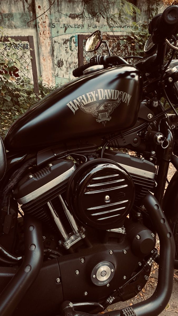 a black motorcycle parked next to a building