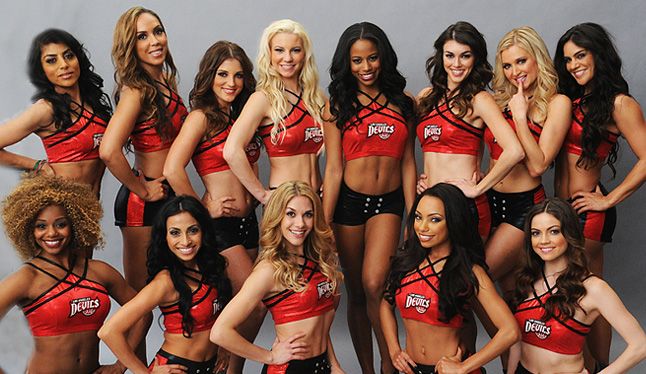 a group of women in red and black cheerleaders posing for a photo together