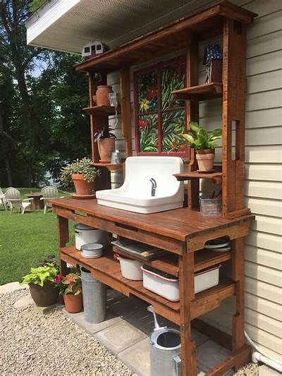 a potted plant sitting on top of a wooden shelf next to a white sink