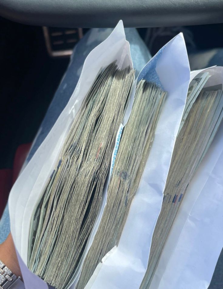 two bundles of money are sitting in the back seat of a car