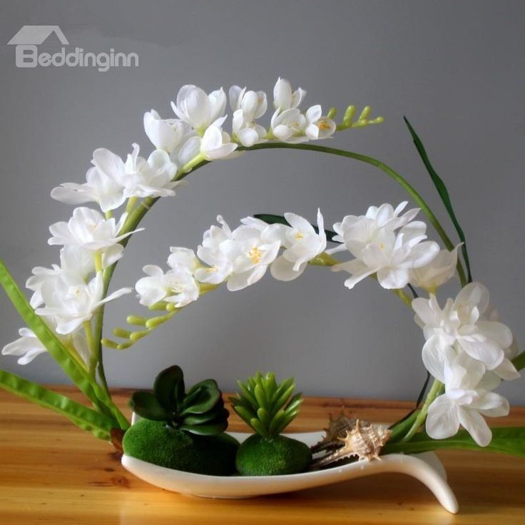 some white flowers are in a bowl on a table