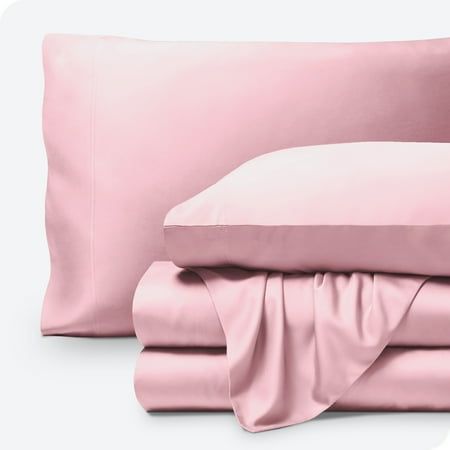 the sheets and pillow cases are folded neatly on top of each other, with a pink satin finish