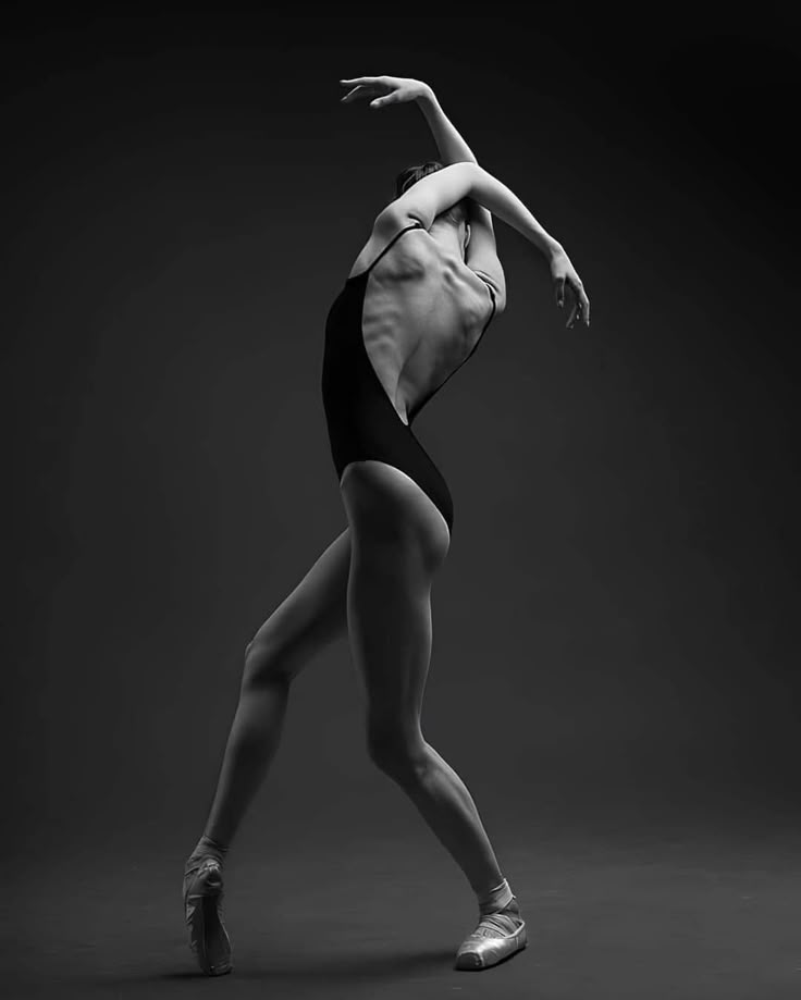 a ballerina in black and white poses for the camera