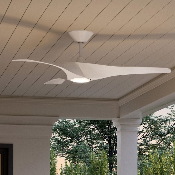 the ceiling fan is attached to the roof of this porch with white columns and pillars