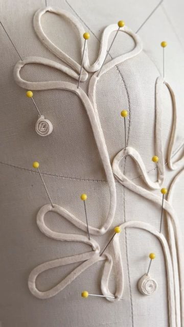 a white pillow with yellow pins on it