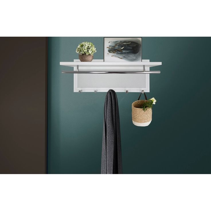 a coat rack with two potted plants on it and hanging from the wall above