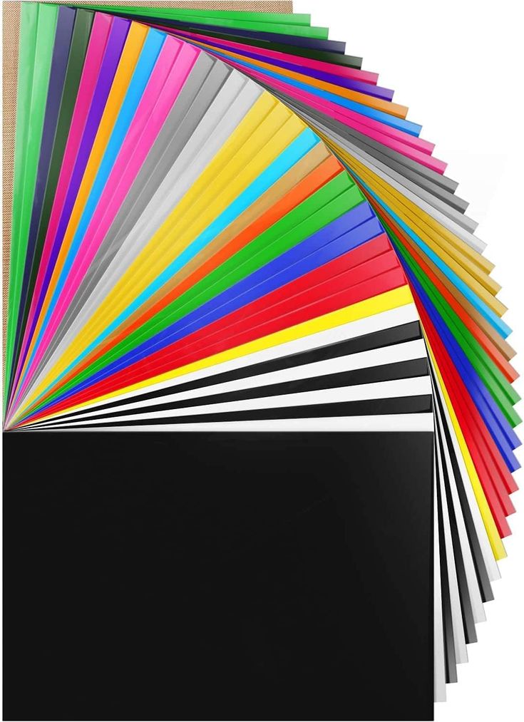 an assortment of different colored papers on top of each other, with one black square in the middle