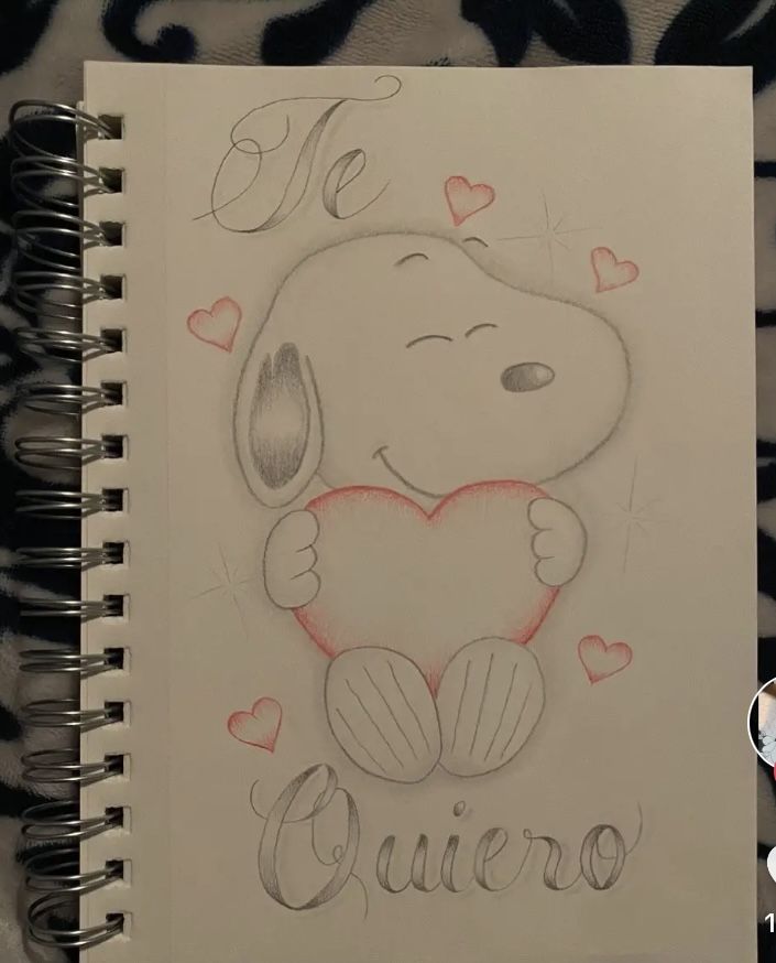 a notebook with a drawing of a dog holding a heart and the words queen written on it