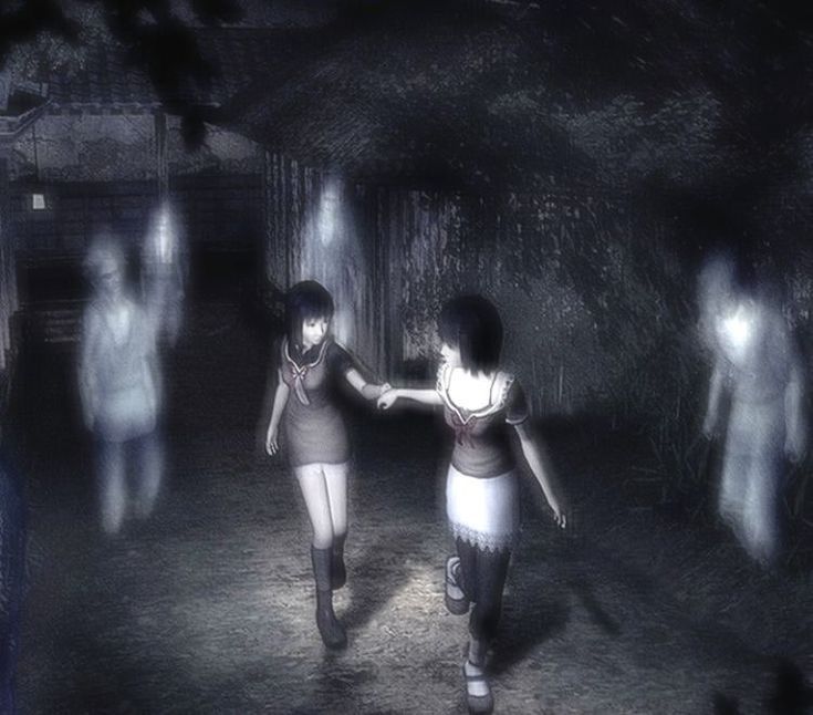 two girls are walking in the dark holding hands