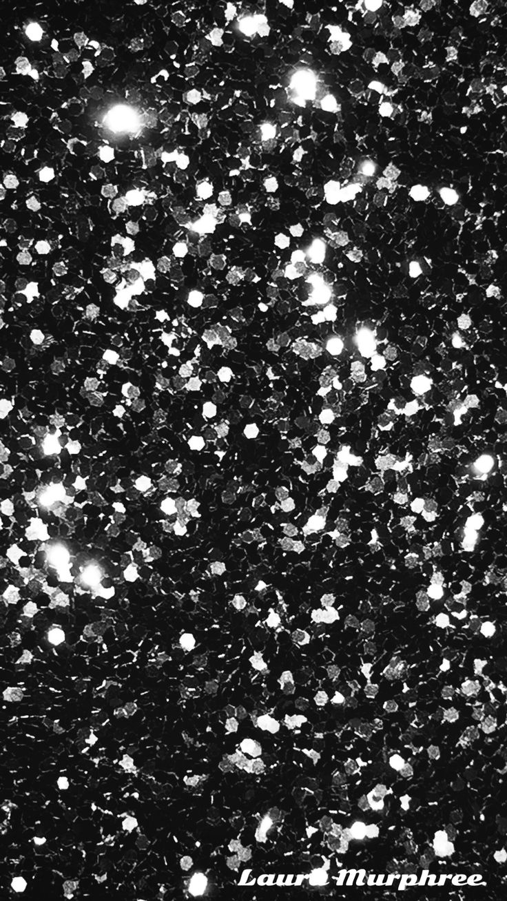 black and white photograph of snow flakes in the night sky