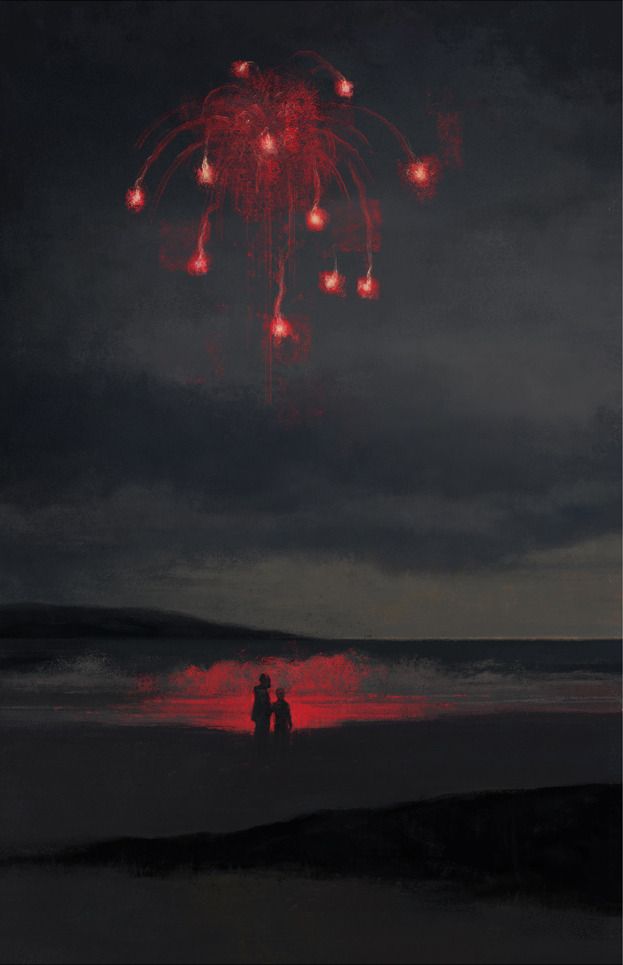 two people standing on the beach watching fireworks