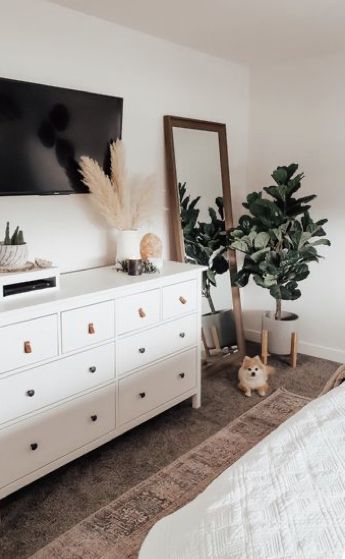 a bedroom with a large flat screen tv on the wall