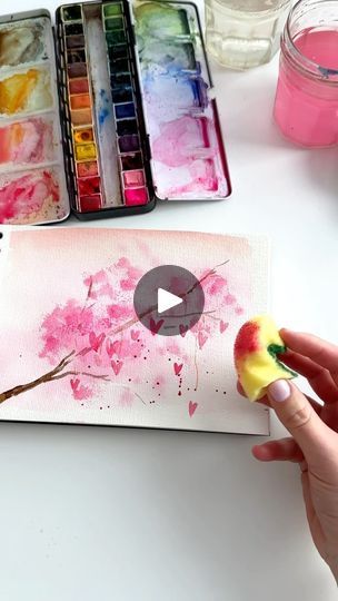 someone is painting an apple with watercolors