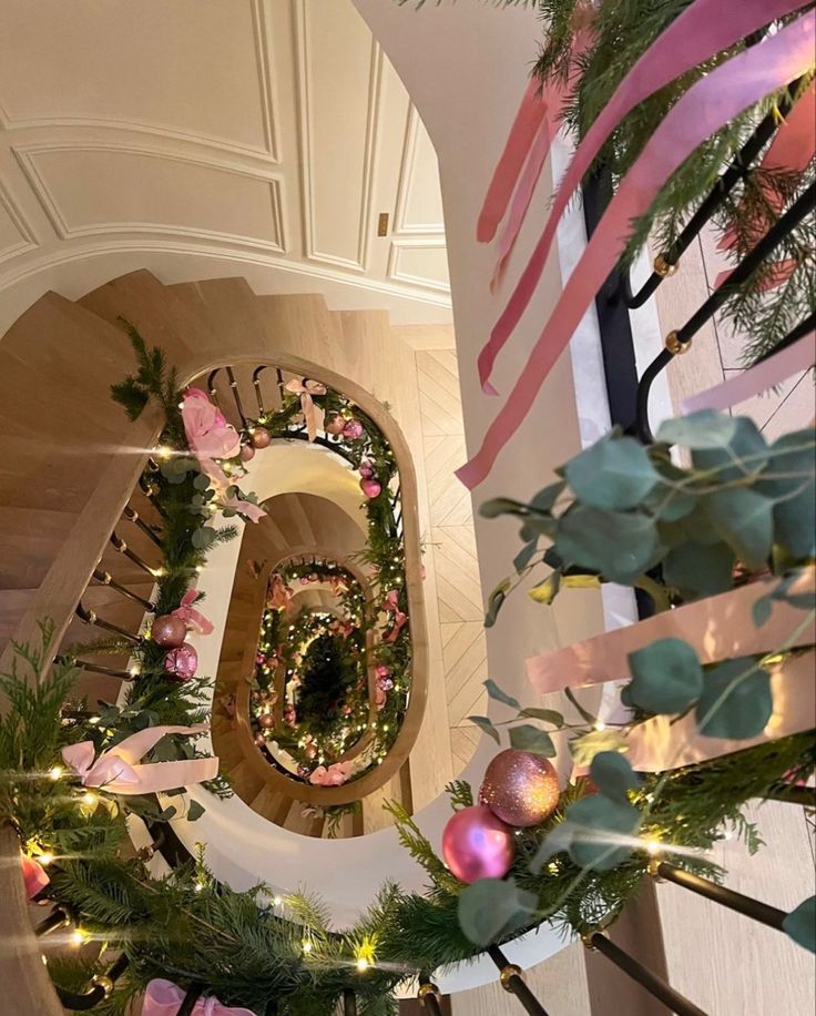 the stairs are decorated with pink and green garlands, ornaments, and ribbons that spell out the number six