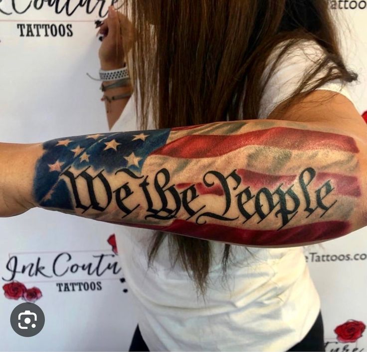 a woman with an american flag tattoo on her arm that says we the people,