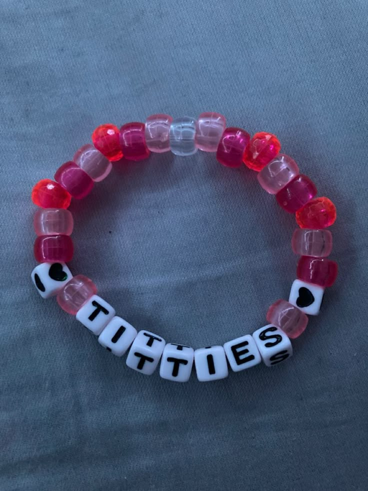 a red and white beaded bracelet with the word turtles on it's side