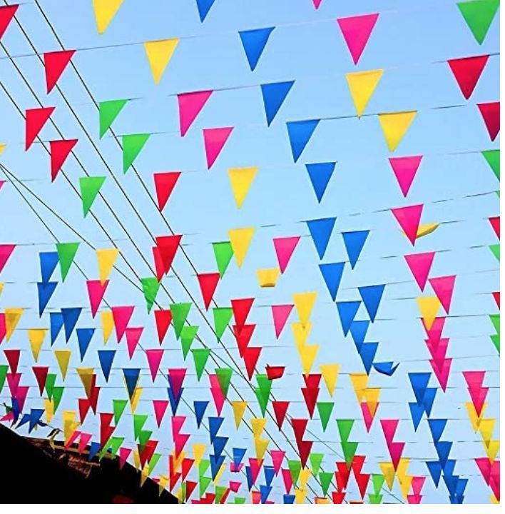 many colorful flags are hanging in the air