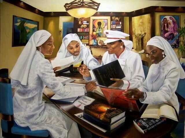 three women sitting at a table with books in front of them and one woman holding a book