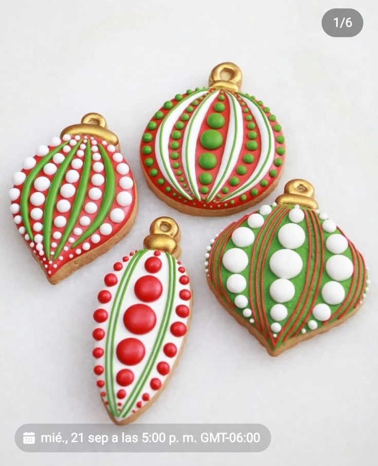 four decorated christmas ornament ornaments on a white surface with red and green accents