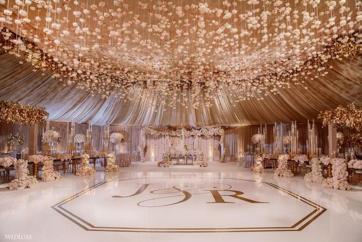 an elaborately decorated ballroom with white and gold decor