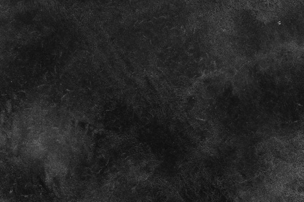 a black and white photo of the surface of an area with dark stains on it