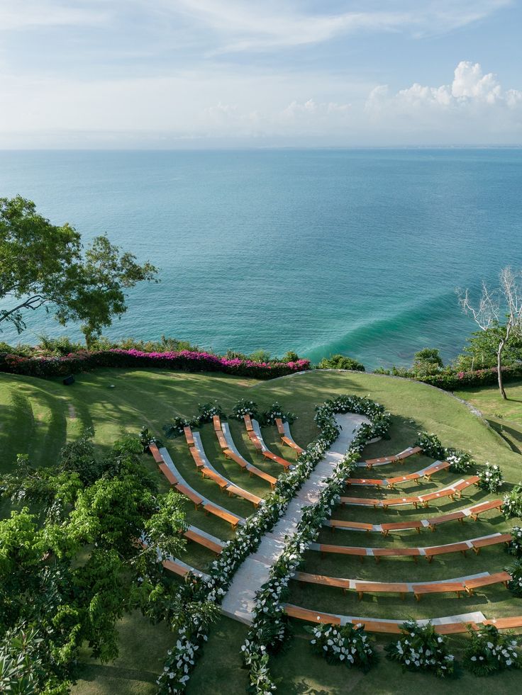 an aerial view of a wedding ceremony setup overlooking the ocean