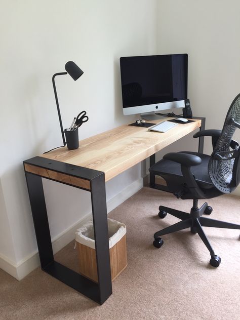 a desk with a chair and a computer on it