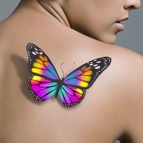 a colorful butterfly on the back of a woman's upper body, with it's wings spread wide open