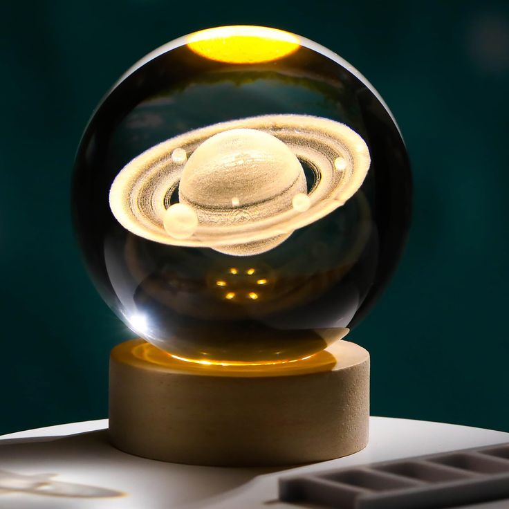 a glass ball with an image of saturn in it