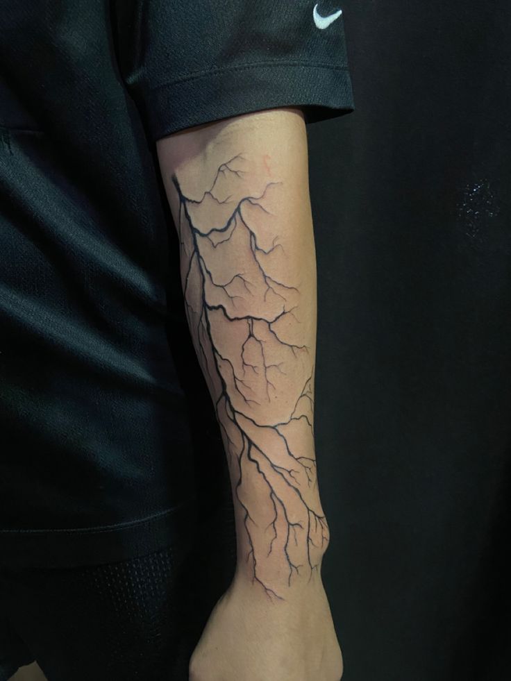 a man with a lightning tattoo on his arm