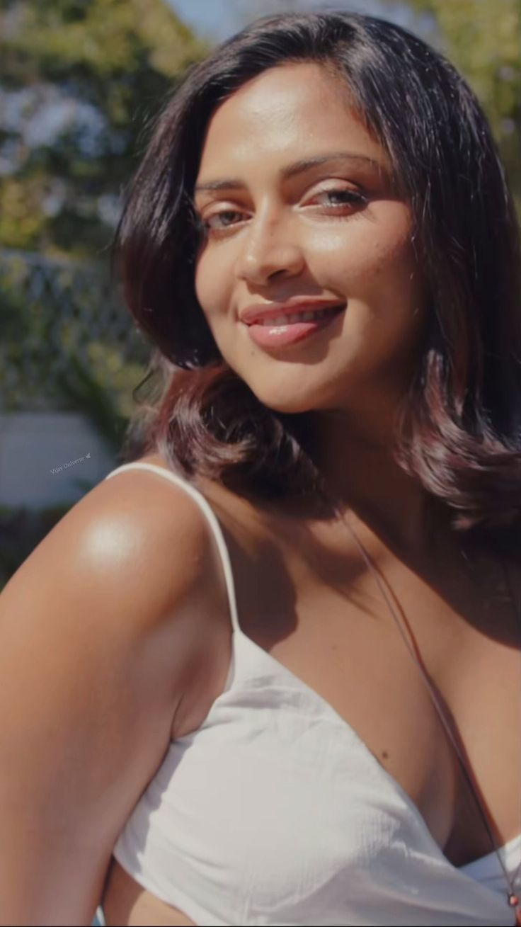 a close up of a person wearing a white shirt