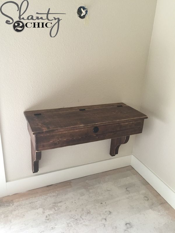 a wooden table sitting in the corner of a room with a sign above it that says shanty society