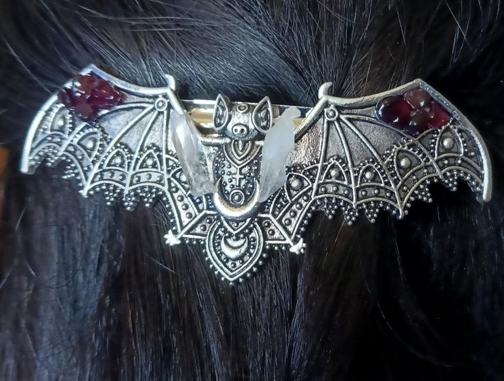 Whimsical Hand saudred stainless steel Bat hair pin. Featuring gorgeous detail in the bat pattern with added mini lumerian points, and garnet gemstone  this hair pin is on the heavier side so I'd recommend using it for thicker hair Bats Nest Hair, Vampire Fashion, Bat Jewelry, Outfit References, Alt Clothes, Bat Pattern, Reno Nv, Thicker Hair, Beautiful Clothes