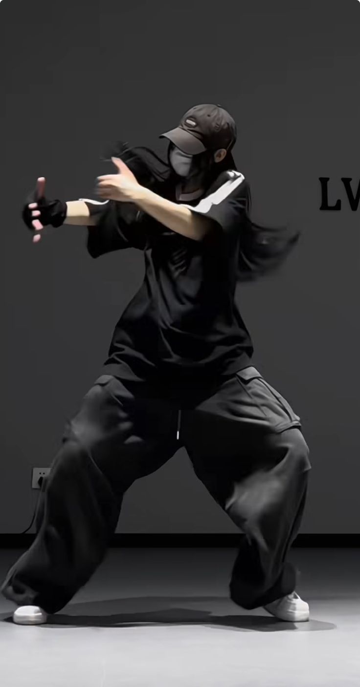 the man is practicing his martial moves in front of a wall with live logo on it