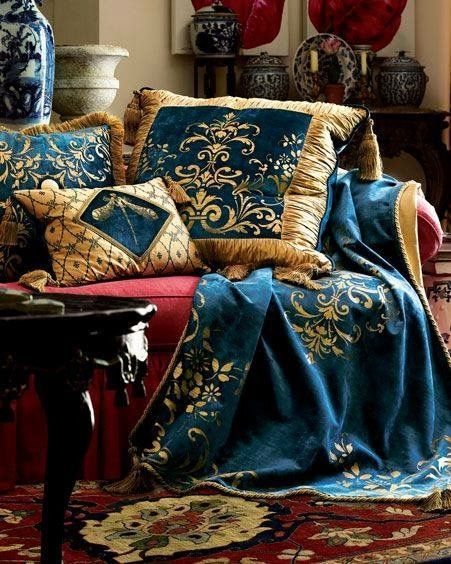 a couch covered in blue and gold pillows