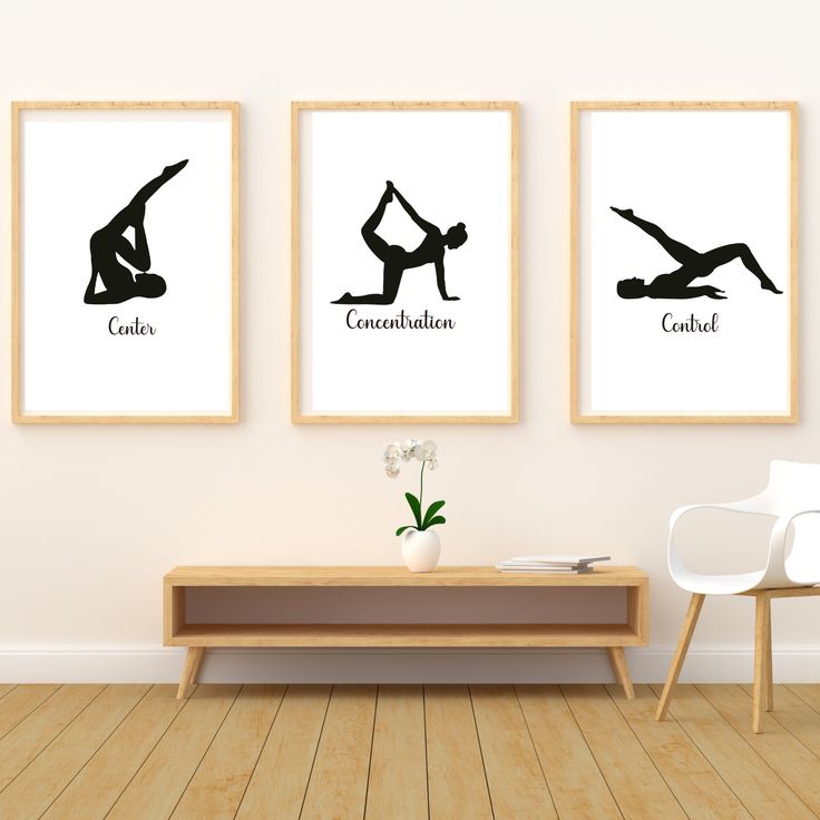 three framed yoga prints on the wall above a coffee table