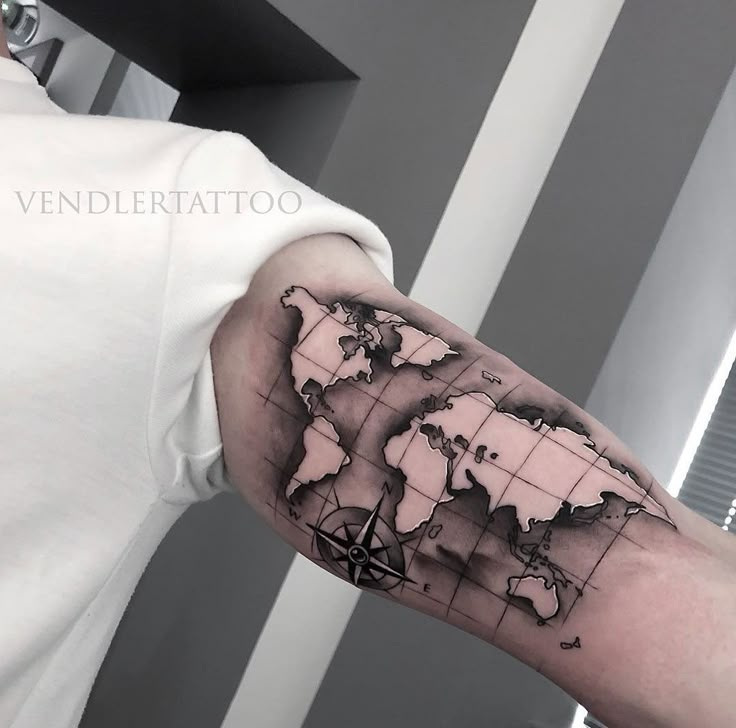 a man with a world map tattoo on his arm